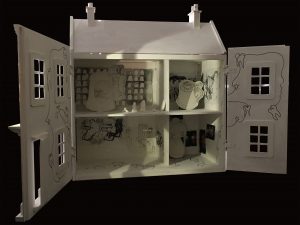 A white 3D dolls house full of mixed media pieces including prints and plaster cast baby teeth.