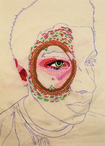 A portrait of a face in blue line on a piece of fabric which has been detailed with stitching around one eye